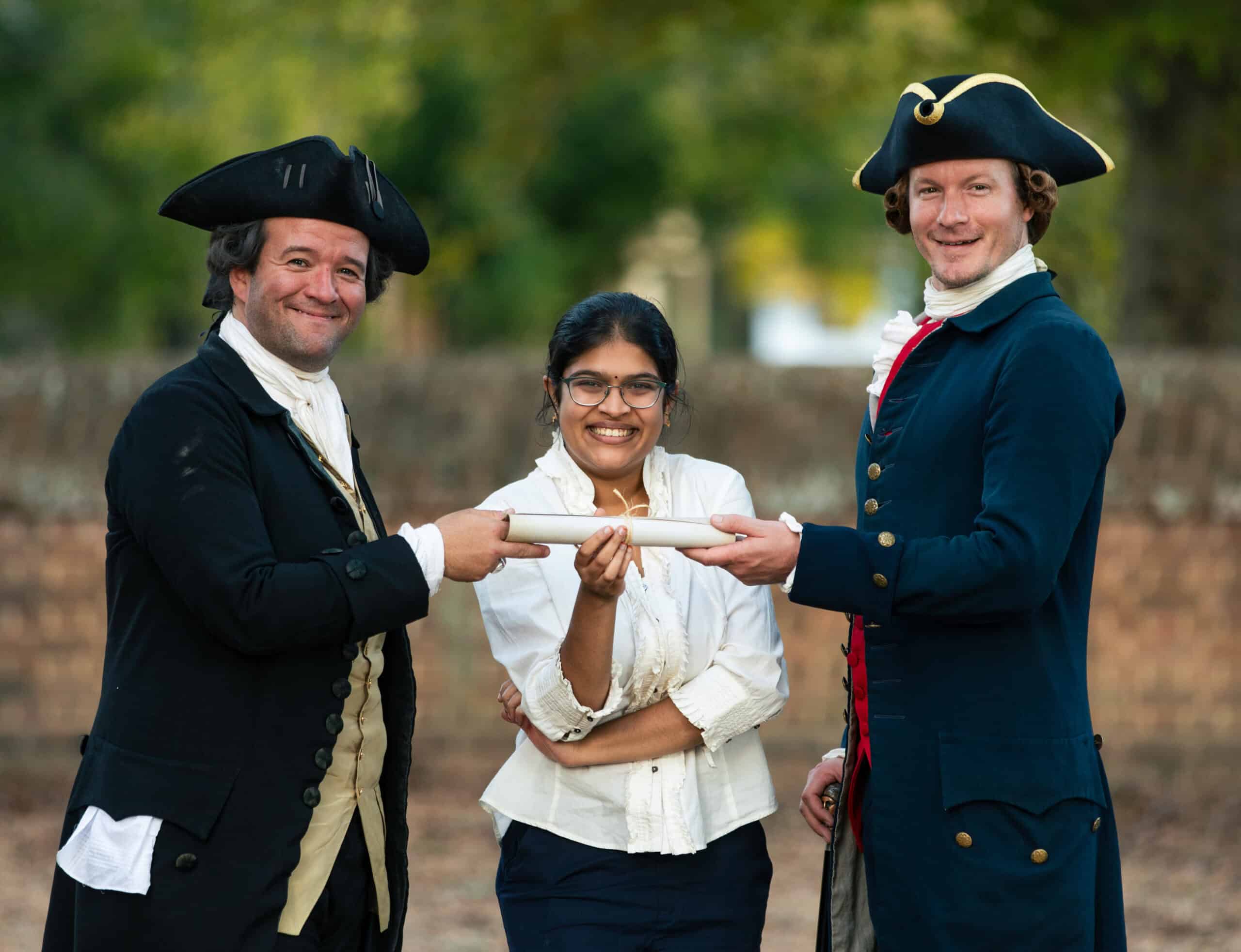 Student poses with founding father interpreters at the Revolutionary Rhetoric speech and debate tournament in Williamsburg, Virginia